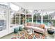 Bright sunroom featuring a sofa, colorful rug, and lots of light at 6630 Gulfport S Blvd, South Pasadena, FL 33707