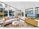 Sunroom featuring a comfortable seating area and large windows overlooking the landscaped yard at 6630 Gulfport S Blvd, South Pasadena, FL 33707