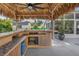 Outdoor tiki bar with natural accents includes a stone countertop and additional bar seating on patio at 6630 Gulfport S Blvd, South Pasadena, FL 33707