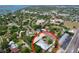 Aerial view of a neighborhood with mature trees, waterways, and a home with a metal roof at 6920 Bougainvilla S Ave, St Petersburg, FL 33707