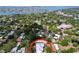 Aerial view of the property with a new silver roof, mature trees, in a waterfront neighborhood at 6920 Bougainvilla S Ave, St Petersburg, FL 33707