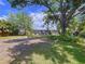 Expansive backyard showcasing the home's rear exterior, mature trees, and ample outdoor space at 6920 Bougainvilla S Ave, St Petersburg, FL 33707
