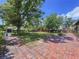 Large, shady backyard with mature trees, storage shed, and brick pathway at 6920 Bougainvilla S Ave, St Petersburg, FL 33707