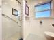 Bathroom showcasing a glass-enclosed shower, toilet, and stained glass window at 6920 Bougainvilla S Ave, St Petersburg, FL 33707
