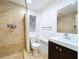 Bathroom with tiled shower, modern fixtures, and vanity with storage at 6920 Bougainvilla S Ave, St Petersburg, FL 33707