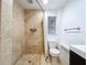 Modern bathroom featuring a tile shower, a toilet, and a window for natural light at 6920 Bougainvilla S Ave, St Petersburg, FL 33707