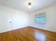 Bright, simple bedroom featuring hardwood floors, neutral walls, and a window at 6920 Bougainvilla S Ave, St Petersburg, FL 33707