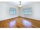 Simple bedroom with hardwood floors, two windows, and ample natural light at 6920 Bougainvilla S Ave, St Petersburg, FL 33707