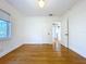 Bedroom boasts hardwood floors, white walls, closet, and views to bathroom and kitchen at 6920 Bougainvilla S Ave, St Petersburg, FL 33707