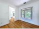 Cozy bedroom with hardwood floors and a large window for natural lighting at 6920 Bougainvilla S Ave, St Petersburg, FL 33707