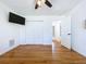 Bedroom with hardwood floors, white walls, closet, and a ceiling fan at 6920 Bougainvilla S Ave, St Petersburg, FL 33707