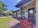 Charming home exterior with brick pathway leading to the entrance, showcasing a well-maintained lawn and delightful curb appeal at 6920 Bougainvilla S Ave, St Petersburg, FL 33707
