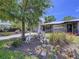 Frontal view of an elegant home with mature trees, giraffe statues, rock features, and lush landscaping at 6920 Bougainvilla S Ave, St Petersburg, FL 33707