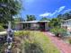 Well maintained single-story home with a brick path, mature landscaping and a tranquil pond at 6920 Bougainvilla S Ave, St Petersburg, FL 33707