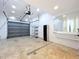 Spacious garage featuring an automatic door opener, epoxy floors, and ample shelving for storage at 6920 Bougainvilla S Ave, St Petersburg, FL 33707