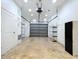 Clean garage with epoxy floor, shelving, and an automatic door opener, perfect for storage and projects at 6920 Bougainvilla S Ave, St Petersburg, FL 33707