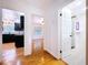 Hallway featuring entrances to the kitchen, bathroom, and bedroom with hardwood flooring at 6920 Bougainvilla S Ave, St Petersburg, FL 33707