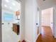 Hallway view leading to a bathroom with tiled flooring and another room with hardwood floors at 6920 Bougainvilla S Ave, St Petersburg, FL 33707