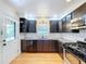 Cozy kitchen with dark cabinetry, stainless steel appliances, and white subway tile backsplash at 6920 Bougainvilla S Ave, St Petersburg, FL 33707