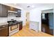Cozy kitchen with stainless steel appliances, dark cabinets, white subway tiles, and hardwood flooring at 6920 Bougainvilla S Ave, St Petersburg, FL 33707
