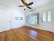 Charming living room with hardwood floors, ceiling fan, and ample natural light from the front door window at 6920 Bougainvilla S Ave, St Petersburg, FL 33707