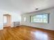 Spacious living room featuring hardwood floors and a large window for natural light at 6920 Bougainvilla S Ave, St Petersburg, FL 33707