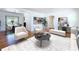 Open-concept living room flows to dining area, featuring hardwood floors and natural light at 6920 Bougainvilla S Ave, St Petersburg, FL 33707