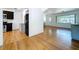 Inviting living room with hardwood floors, large window, and an open flow to the kitchen for easy entertaining at 6920 Bougainvilla S Ave, St Petersburg, FL 33707