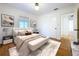 Relaxing main bedroom features neutral décor, hardwood floors, white walls, and a cozy bench at 6920 Bougainvilla S Ave, St Petersburg, FL 33707