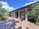 Inviting outdoor patio with brick flooring and comfortable seating, perfect for enjoying the serene and beautifully landscaped surroundings at 6920 Bougainvilla S Ave, St Petersburg, FL 33707