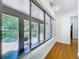 Bright sunroom with expansive windows offering views of the outdoor patio and greenery at 6920 Bougainvilla S Ave, St Petersburg, FL 33707