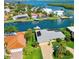 Waterfront property with a private pool and boat dock, surrounded by lush landscaping and canals at 781 Binnacle Point Dr, Longboat Key, FL 34228