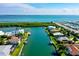 Beautiful aerial view of waterfront homes on a canal, featuring pools, docks, and lush landscaping at 781 Binnacle Point Dr, Longboat Key, FL 34228