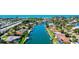 Scenic aerial view of a canal-front home with a pool and boat dock, showcasing the waterfront community at 781 Binnacle Point Dr, Longboat Key, FL 34228