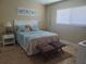 Comfortable guest bedroom with coastal decor and travertine floors at 781 Binnacle Point Dr, Longboat Key, FL 34228