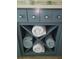 Custom bathroom cabinetry features open towel storage and seaside knobs at 781 Binnacle Point Dr, Longboat Key, FL 34228