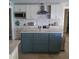 Modern kitchen with stainless steel appliances, stylish backsplash, and a functional center island at 781 Binnacle Point Dr, Longboat Key, FL 34228