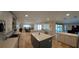 Spacious kitchen overlooking living spaces with an island, modern appliances, and ample countertop space at 781 Binnacle Point Dr, Longboat Key, FL 34228