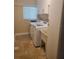 Laundry room with washer, dryer, wash basin and storage cabinets at 781 Binnacle Point Dr, Longboat Key, FL 34228