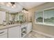 Double sink vanity with granite countertops, tiled backsplash and shelf at 781 Binnacle Point Dr, Longboat Key, FL 34228
