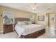 Comfortable main bedroom with a ceiling fan, bedside table and artwork at 781 Binnacle Point Dr, Longboat Key, FL 34228
