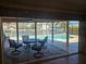 Inviting covered patio overlooking a sparkling pool and canal, seamlessly blending indoor-outdoor living at 781 Binnacle Point Dr, Longboat Key, FL 34228