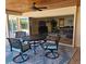 Covered outdoor patio with a ceiling fan and stylish furniture, perfect for relaxation and entertaining at 781 Binnacle Point Dr, Longboat Key, FL 34228