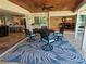 Covered patio with comfortable seating offers serene views of the open kitchen and dining room at 781 Binnacle Point Dr, Longboat Key, FL 34228