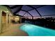 Relaxing pool area with outdoor seating and a view of the tranquil evening sky at 781 Binnacle Point Dr, Longboat Key, FL 34228