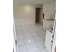 Bright, spacious kitchen area with white tile flooring and updated cabinets at 8225 Krag Dr, Hudson, FL 34667