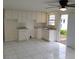 Bright kitchen with white cabinets, marble countertops, and open access to the backyard at 8225 Krag Dr, Hudson, FL 34667