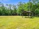 Large backyard featuring a shelter, a pasture, and lush surroundings at 876 Ranch Rd, Tarpon Springs, FL 34688