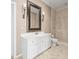 Elegant bathroom featuring a stylish vanity, and a walk-in shower with a glass enclosure at 876 Ranch Rd, Tarpon Springs, FL 34688