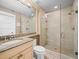Bathroom with a walk-in shower, tiled walls, granite counter, and modern fixtures at 876 Ranch Rd, Tarpon Springs, FL 34688